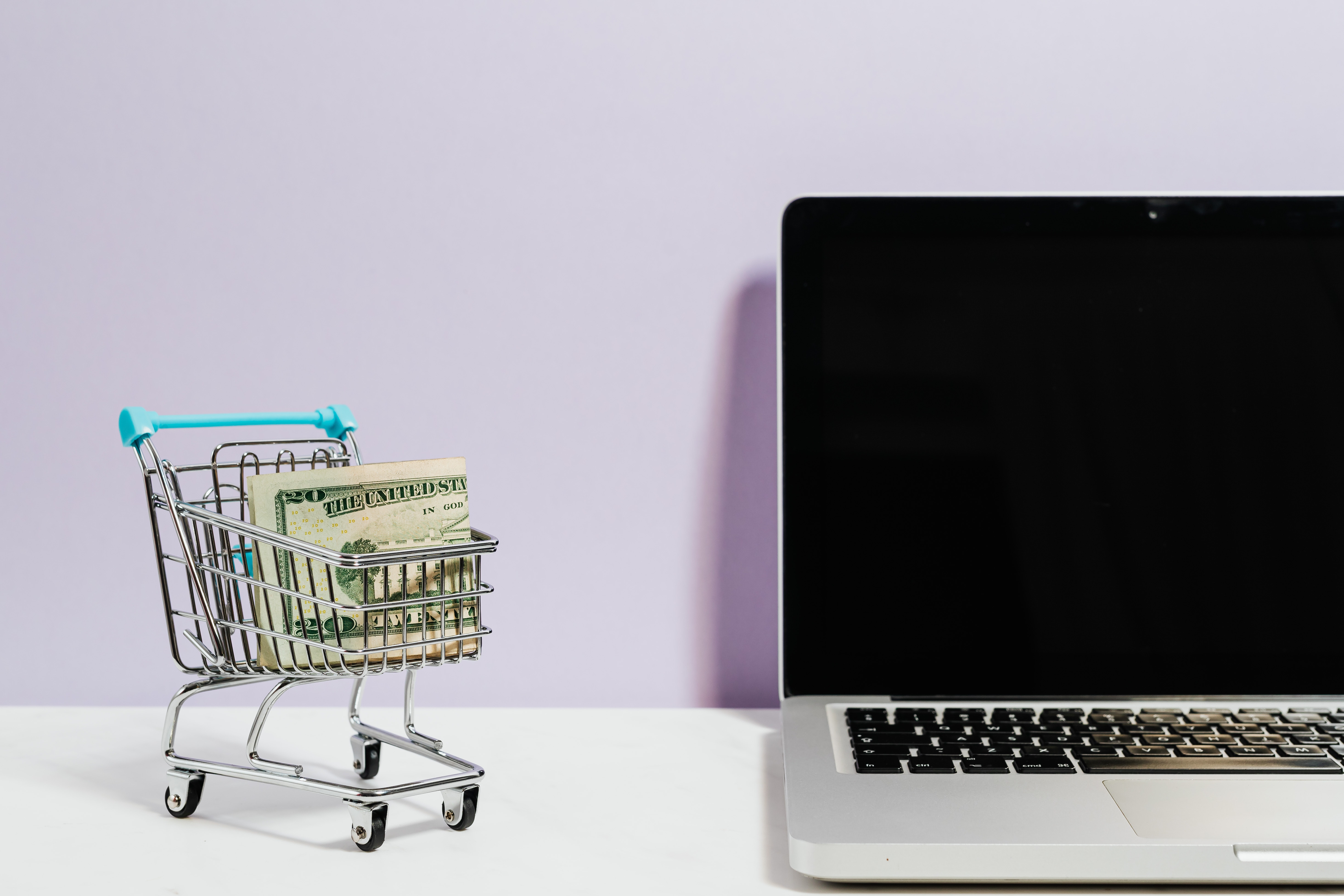 tiny shopping cart parked next to laptop