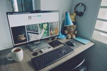 A lovely desk with a computer displaying a website.
